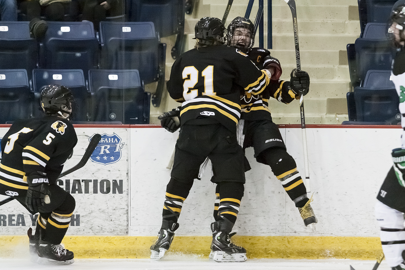 IM Kyle Sylvester, Jared Bethune, and Koby Roth celebrate after Sylvester ties the game in the second period.G_8327