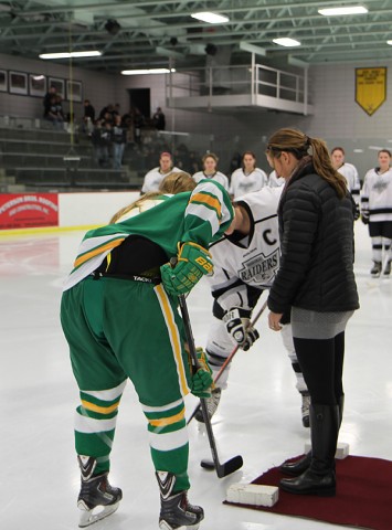 Former Roseville star Winny (Brodt) Brown takes part in the ceremonial pre-game puck drop.