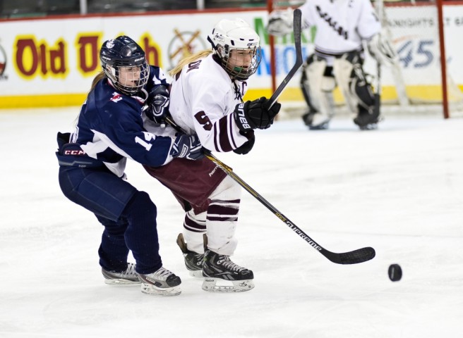 Hibbing/Chisholm's Lilly Rewertz tries to slow down South St. Paul's Anna Barlow in the Packers' 5-1 Class 1A quarterfinal win on Wednesday night at Xcel Energy Center. (MHM Photo / Tim Kolehmainen)